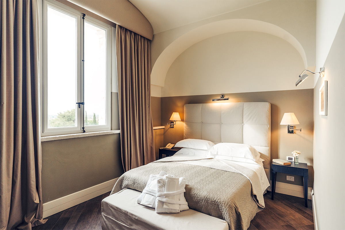 Aurora Comfort room with double bed, large window and vaulted ceiling.