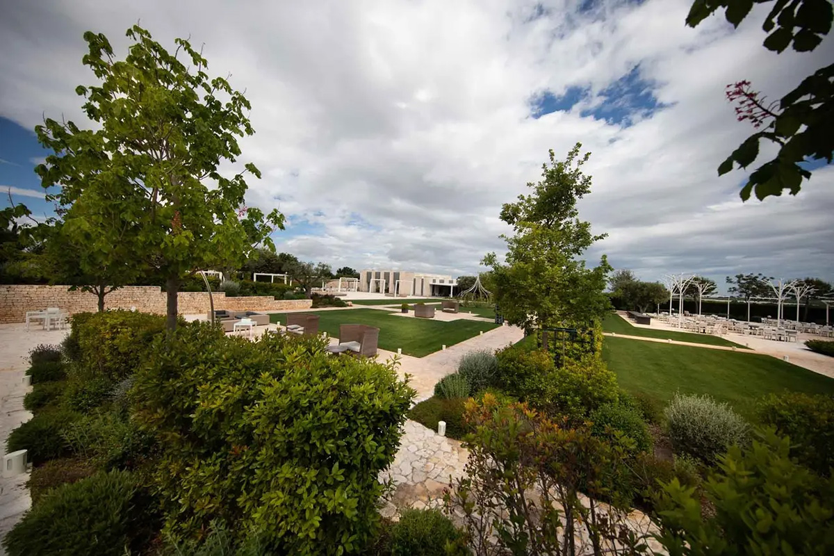 Panoramic garden with hedges, trees and views of the event venue.