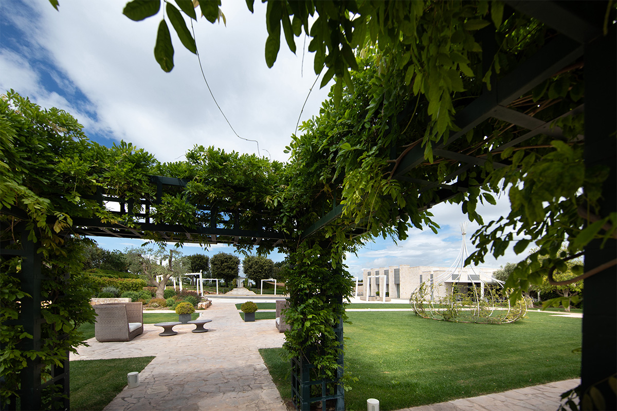 Pergola in the Arena della Gioia garden, set up for outdoor events.