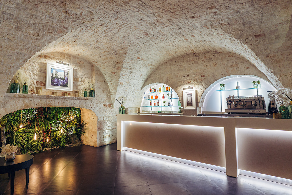 Bar counter in a vaulted stone hall.