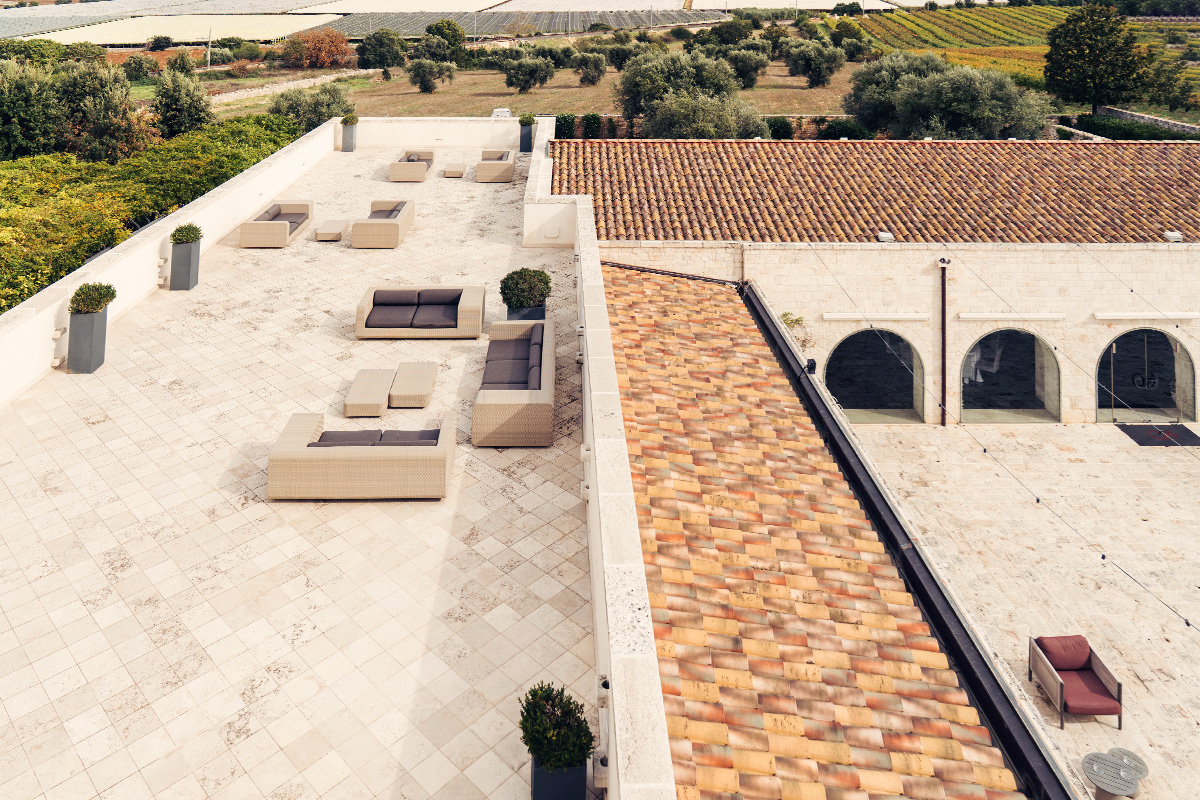 Panoramic rooftop terrace at the historic Palazzo with countryside view and arched loggia.