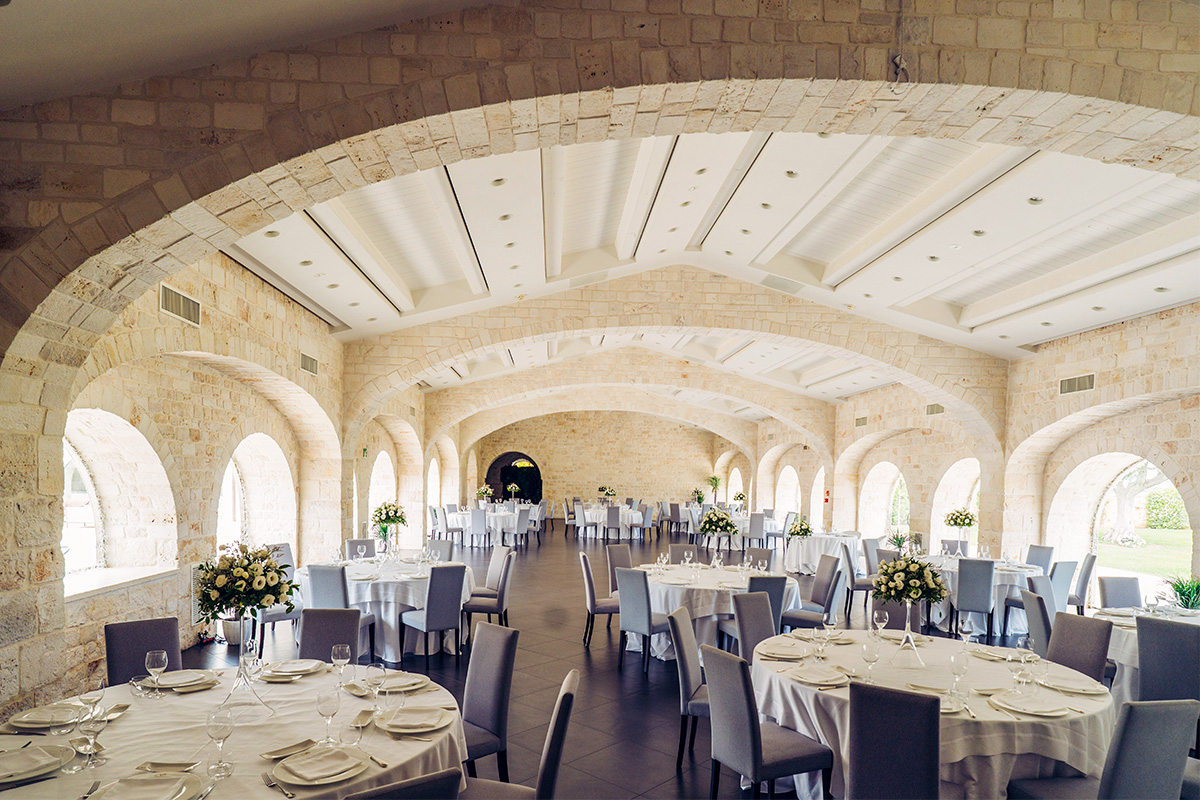 Wedding banquet in an arched reception hall at Il Santissimo palace.