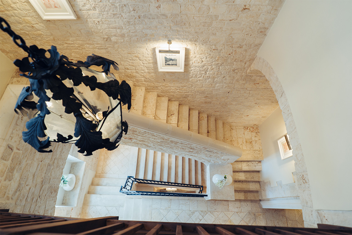 Interior staircase of the palace with stone steps and vaulted ceiling.