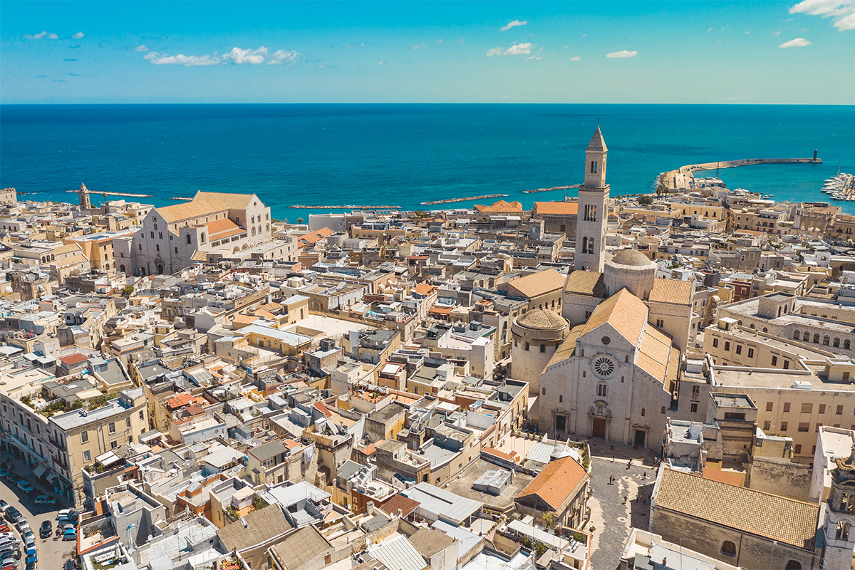 Aerial view of Bari old town with the Cathedral, the Basilica of San Nicola, the historic center and the Adriatic Sea in the background. 